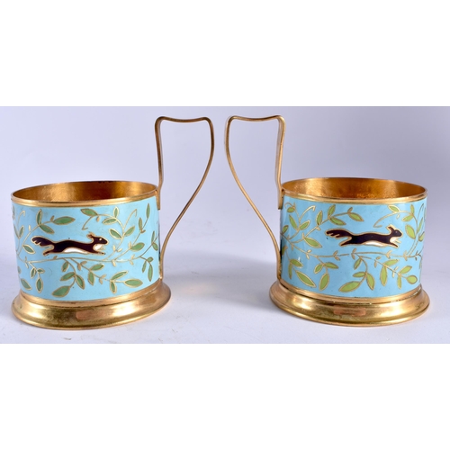 718 - A PAIR OF RUSSIAN YELLOW METAL AND ENAMEL CUP HOLDERS. 9 cm wide.