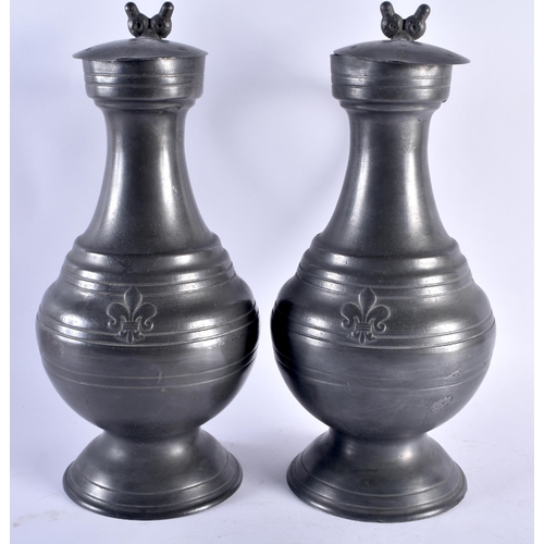 719 - A LARGE PAIR OF ANTIQUE FRENCH PEWTER FLAGONS. 37 cm high.