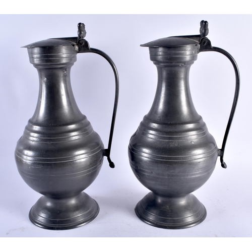 719 - A LARGE PAIR OF ANTIQUE FRENCH PEWTER FLAGONS. 37 cm high.