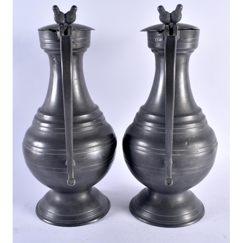 719 - A LARGE PAIR OF ANTIQUE FRENCH PEWTER FLAGONS. 37 cm high.