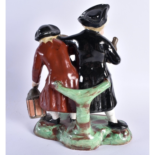 731 - A 19TH CENTURY STAFFORDSHIRE POTTERY FIGURE OF TWO DRUNKEN MALES together with a Staffordshire spani... 