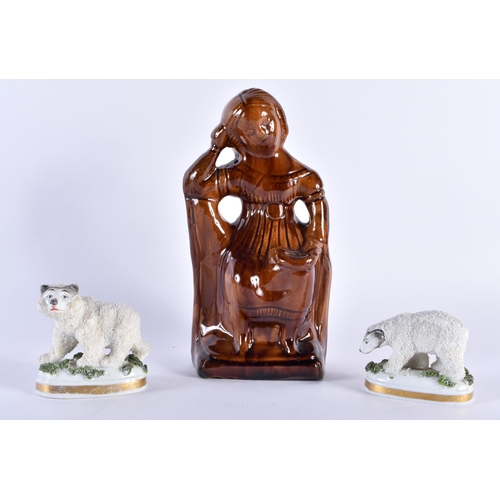 754 - AN ANTIQUE TREACLE GLAZED FIGURAL MONEY BOX together with a pair of Continental porcelain polar bear... 