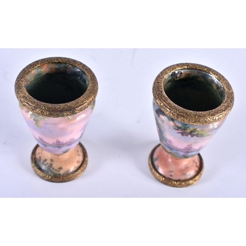 768 - A PAIR OF EARLY 20TH CENTURY FRENCH ENAMELLED VASES painted with landscapes. 6 cm x 4 cm.