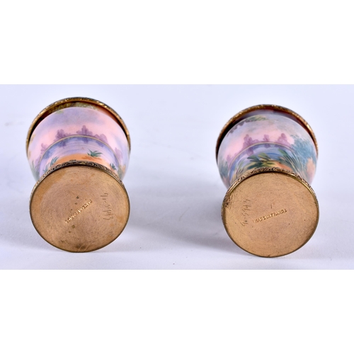 768 - A PAIR OF EARLY 20TH CENTURY FRENCH ENAMELLED VASES painted with landscapes. 6 cm x 4 cm.