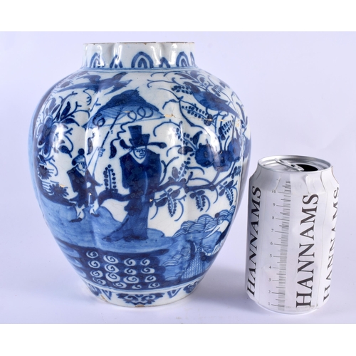 90 - AN 18TH CENTURY DUTCH DELFT RIBBED BLUE AND WHITE POTTERY VASE painted with Oriental figures within ... 