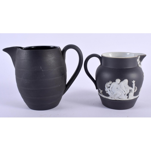 99 - TWO RARE MINIATURE WEDGWOOD BLACK JASPERWARE CREAM JUGS. Largest 7 cm x 8 cm. (2)