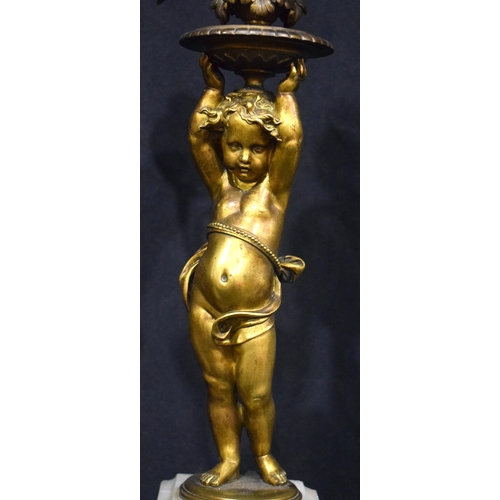 3993 - A pair of Putti bronze candelabras set on a marble base  68 cm (2)