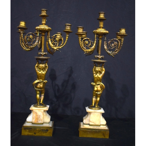 3993 - A pair of Putti bronze candelabras set on a marble base  68 cm (2)