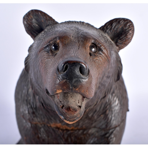 141 - A 19TH CENTURY BAVARIAN BLACK FOREST CARVED WOOD TOBACCO JAR AND COVER formed as a seated bear, mode... 