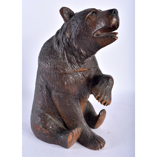 141 - A 19TH CENTURY BAVARIAN BLACK FOREST CARVED WOOD TOBACCO JAR AND COVER formed as a seated bear, mode... 