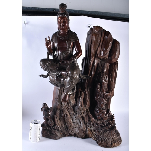 627 - A VERY LARGE AND UNUSUAL 19TH CENTURY CHINESE BRONZE AND ROOTWOOD SCULPTURE formed with Quanyin seat... 