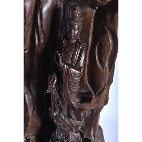 627 - A VERY LARGE AND UNUSUAL 19TH CENTURY CHINESE BRONZE AND ROOTWOOD SCULPTURE formed with Quanyin seat... 