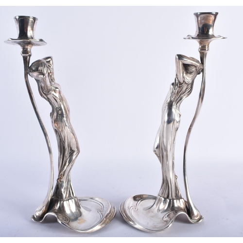 91 - A STYLISH PAIR OF ART NOUVEAU WMF SILVER PLATED CANDLE STICKS formed as classical maidens wearing lo... 