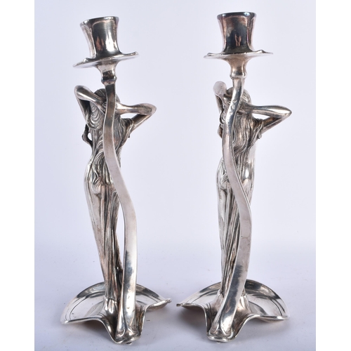 91 - A STYLISH PAIR OF ART NOUVEAU WMF SILVER PLATED CANDLE STICKS formed as classical maidens wearing lo... 