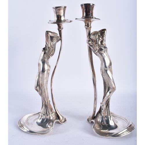 91 - A STYLISH PAIR OF ART NOUVEAU WMF SILVER PLATED CANDLE STICKS formed as classical maidens wearing lo... 