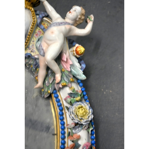 115E - A VERY LARGE 19TH CENTURY GERMAN MEISSEN PORCELAIN MIRROR set with two putti encasing a portrait of ... 