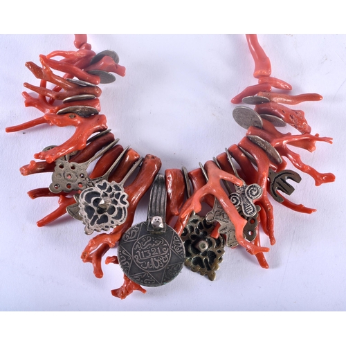 35C - AN UNUSUAL 19TH CENTURY MIDDLE EASTERN ISLAMIC STICK CORAL NECKLACE set with a central Islamic coin.... 