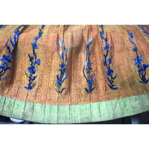 75E - A 19TH CENTURY ORANGE EMBROIDERED SILK WORK SKIRT Qing, decorated with foliage and vines. 105 cm x 1... 