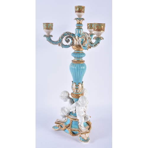 109 - A LARGE 19TH CENTURY ENGLISH SEVRES STYLE PORCELAIN BLUE GLAZED CANDELABRA formed with three cherubs... 