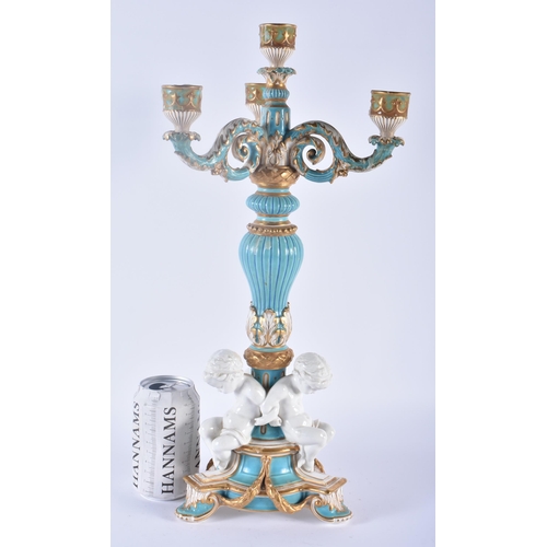 109 - A LARGE 19TH CENTURY ENGLISH SEVRES STYLE PORCELAIN BLUE GLAZED CANDELABRA formed with three cherubs... 