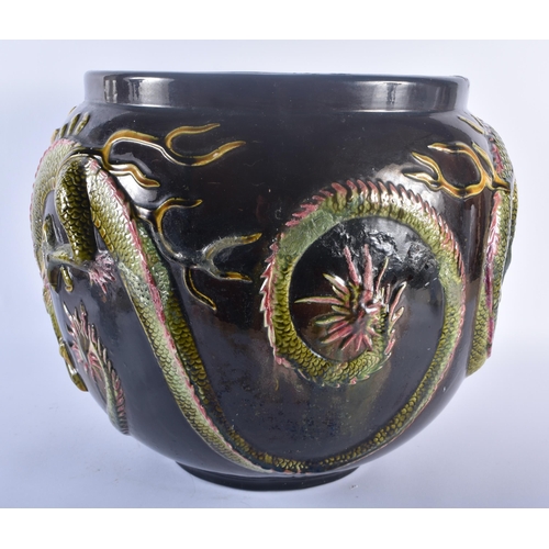 111 - A VERY LARGE BRETBY POTTERY DRAGON JARDINIERE modelled pursuing a flaming pearl. 34 cm x 34 cm.