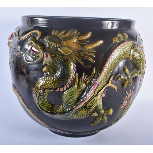 111 - A VERY LARGE BRETBY POTTERY DRAGON JARDINIERE modelled pursuing a flaming pearl. 34 cm x 34 cm.