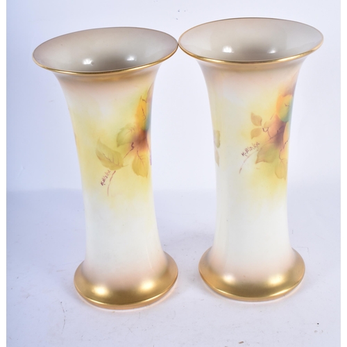 115 - A PAIR OF ROYAL WORCESTER BLUSH IVORY VASES by Kitty Blake. 19 cm high.