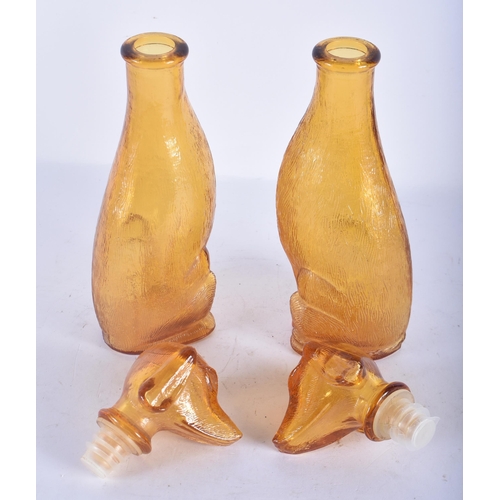 116 - A PAIR OF ART DECO SMOKEY AMBER GLASS DOG DECANTERS AND STOPPERS. 23 cm high.