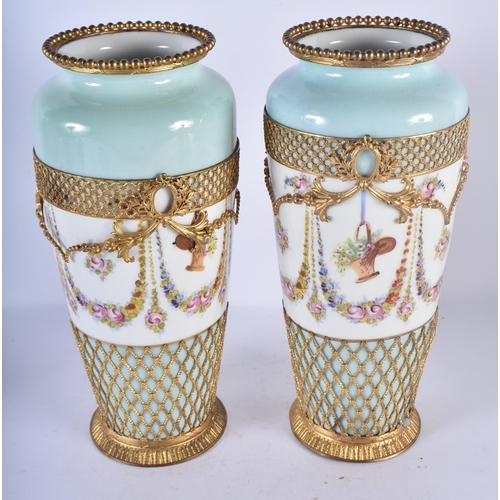 133 - A PAIR OF LATE 19TH CENTURY FRENCH SEVRES STYLE PARIS PORCELAIN VASES overlaid with gilt metal swags... 