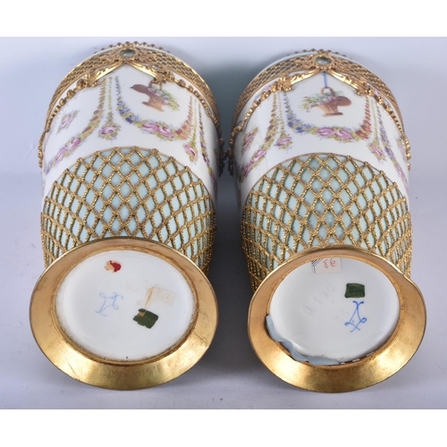 133 - A PAIR OF LATE 19TH CENTURY FRENCH SEVRES STYLE PARIS PORCELAIN VASES overlaid with gilt metal swags... 