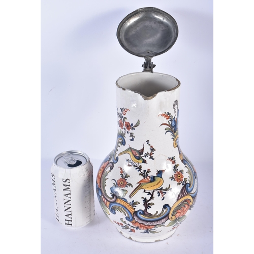 134 - AN 18TH CENTURY EUROPEAN TIN GLAZED FAIENCE JUG with pewter mounts, painted with birds and flowers. ... 