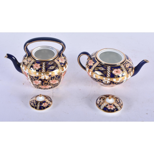 140 - TWO MINIATURE ROYAL CROWN DERBY IMARI TEAPOTS AND COVERS. Largest 7 cm x 8 cm. (2)