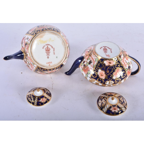 140 - TWO MINIATURE ROYAL CROWN DERBY IMARI TEAPOTS AND COVERS. Largest 7 cm x 8 cm. (2)