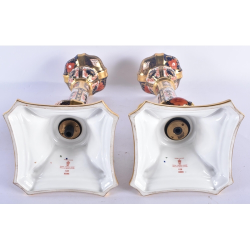 143 - A LARGE PAIR OF ROYAL CROWN DERBY IMARI CANDLESTICKS. 27 cm high.