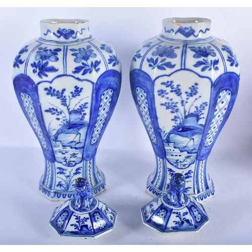 147 - A LARGE PAIR OF 18TH CENTURY DUTCH DELFT BLUE AND WHITE VASES painted with birds in landscapes. 38 c... 