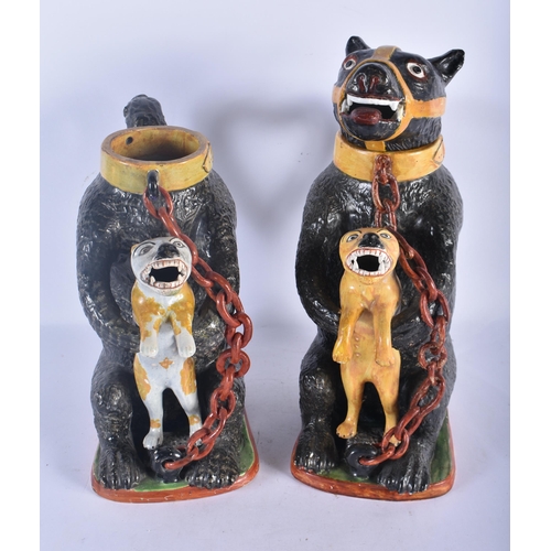 148 - A PAIR OF LATE 18TH/19TH CENTURY PRATTWARE BEAR BAITING JUGS each modelled holding a scowling beast,... 