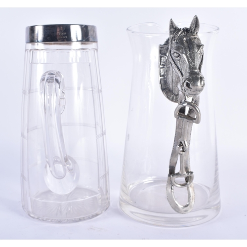 291 - A SILVER PLATED GLASS PITCHER together with a horse head jug. Largest 22 cm x 17 cm. (2)