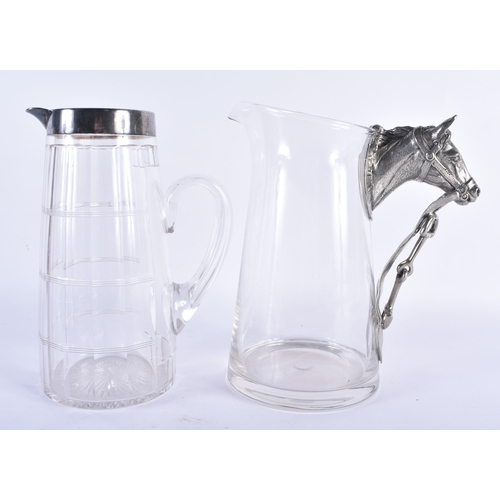 291 - A SILVER PLATED GLASS PITCHER together with a horse head jug. Largest 22 cm x 17 cm. (2)