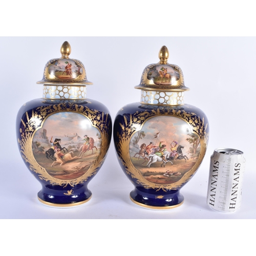 293 - A LARGE PAIR OF 19TH CENTURY GERMAN DRESDEN PORCELAIN VASES AND COVERS painted with fighting scenes.... 