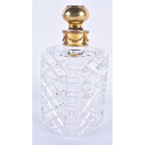 294 - A CONTINENTAL SILVER GILT AND DIAMOND CUT GLASS DECANTER. 22 cm high.