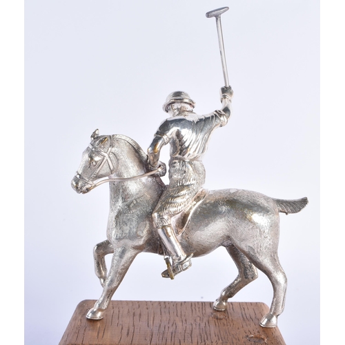 299 - AN ANTIQUE SILVER PLATED AND PINE POLO PLAYER FIGURE. 794 grams. 19 cm x 10 cm.