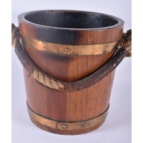 312 - AN EDWARDIAN COUNTRY HOUSE OAK AND BRASS BOUND NAVAL FIRE BUCKET painted with a coat of arms. 34 cm ... 