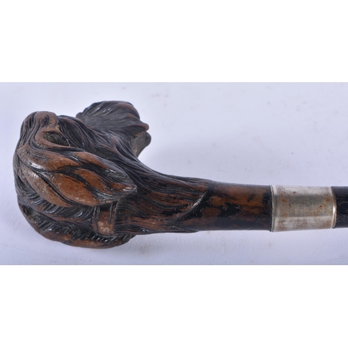 332 - AN ANTIQUE BAVARIAN BLACK FOREST CARVED DOG HEAD SWAGGER STICK. 65 cm long.