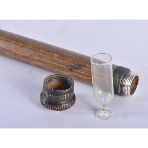 333 - A RARE ANTIQUE COMBINATION WALKING CANE the top opening to reveal a tiny toasting glass, the central... 