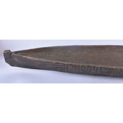 364 - A VERY LARGE EARLY 20TH CENTURY TRIBAL AFRICAN POLYNESIAN CARVED WOOD CANOE. 106 cm x 18cm.