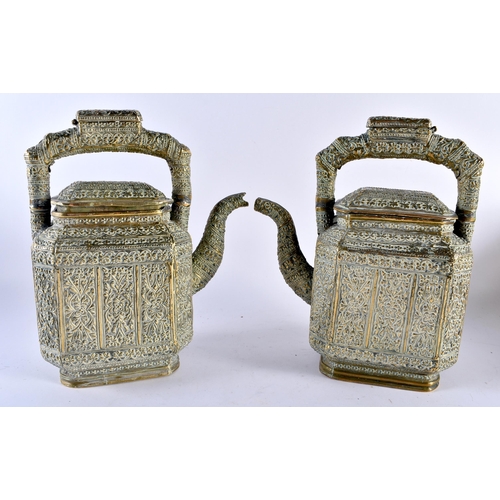 383 - A LARGE PAIR OF 19TH CENTURY INDIAN BRONZE TEAPOTS AND COVERS decorated with floral sprays and vines... 