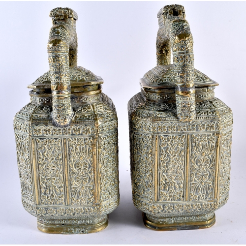 383 - A LARGE PAIR OF 19TH CENTURY INDIAN BRONZE TEAPOTS AND COVERS decorated with floral sprays and vines... 