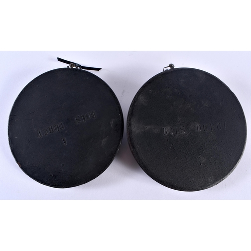 391 - A PAIR OF EARLY VICTORIAN BOIS DURCI PLAQUES Attributed to Francois Lepage. 11cm diameter.