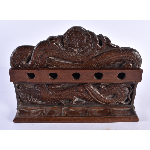 394 - AN EARLY 20TH CENTURY ANGLO INDIAN KASHMIRI CARVED HARDWOOD PIPE STAND CECORATED WITH DRAGONS 22 cm ... 