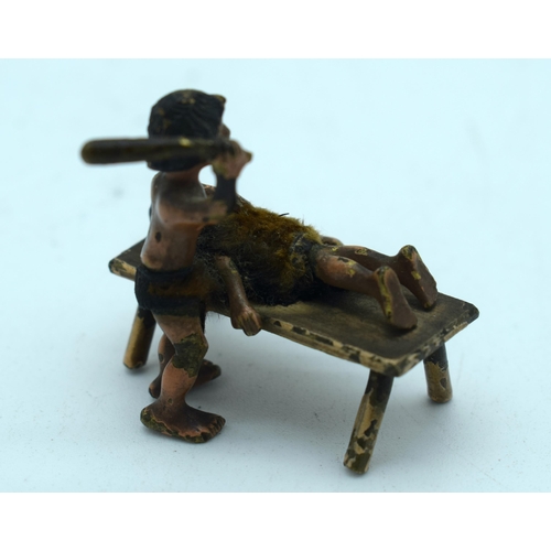 403 - A VERY RARE ANTIQUE COLD PAINTED BRONZE TRIBAL BEATING FIGURE. 22.3 grams. 3.5 cm x 3.5 cm.